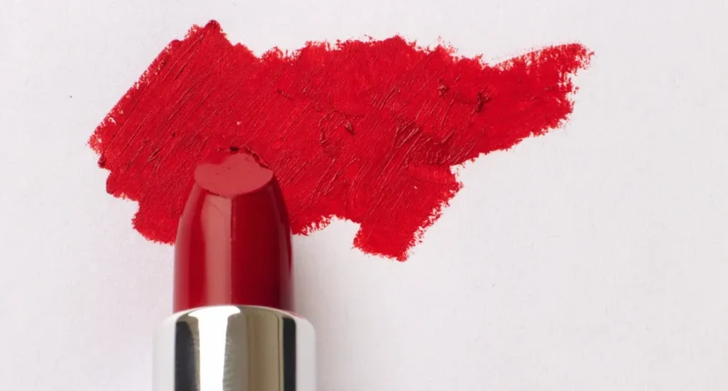 A vibrant swatch of red lipstick on a white background, demonstrating the rich pigment and texture ideal for those with light skin tones