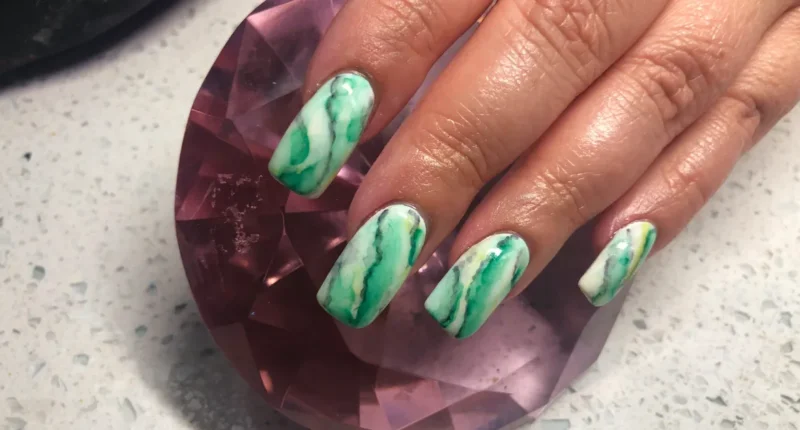 Natural stone inspired green marble nails with realistic textures, perfect for an organic and unique nail design.