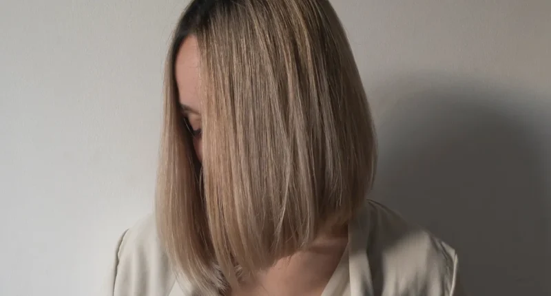 A sleek straight blonde bob with a sharp cut, exuding an air of minimalist elegance associated with old money style, yet perfectly suited for the modern fashion scene.